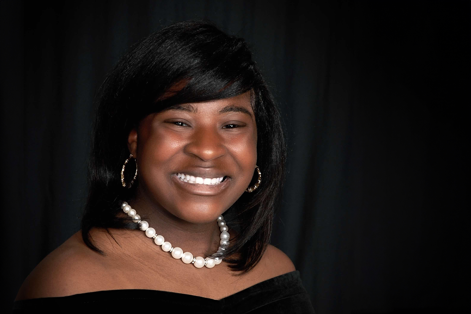 Smiling lady wearing a pearl necklace | Cosmetic Dentistry Cary NC